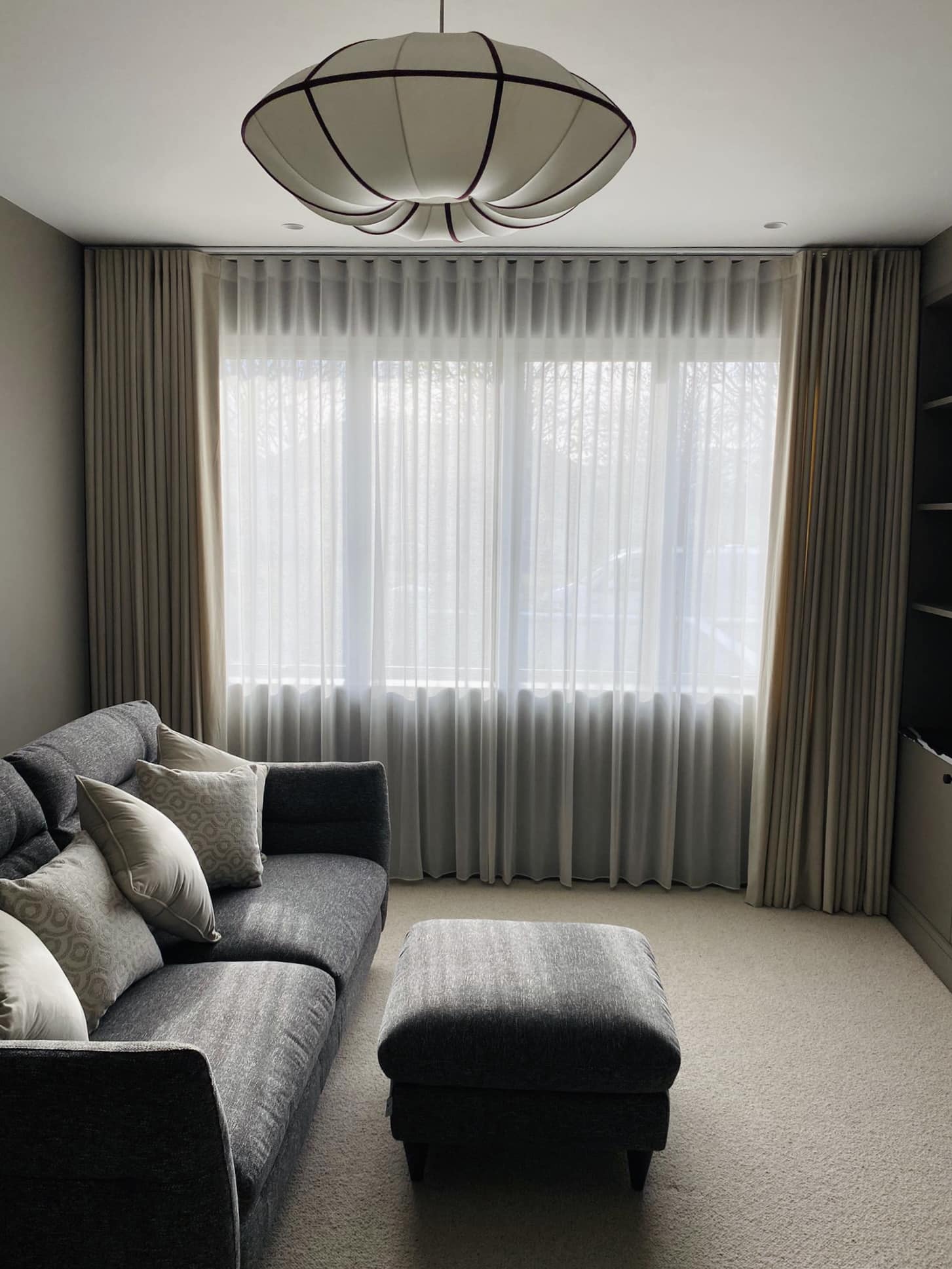 sheer, voile curtains on a ceiling fixed track with standard curtains in a sitting room, the curtains are wall to wall, floor to ceiling